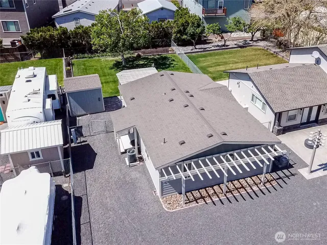 an aerial view of a house with a swimming pool a patio and yard