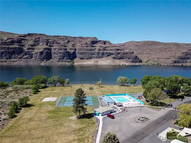 an aerial view of a house with garden space and a car parked on the side of it