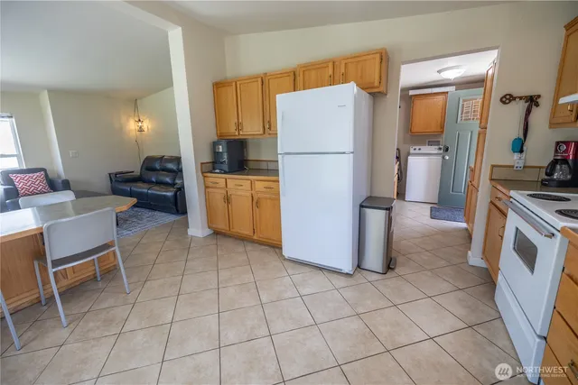 a kitchen with a refrigerator a stove a washer and dryer
