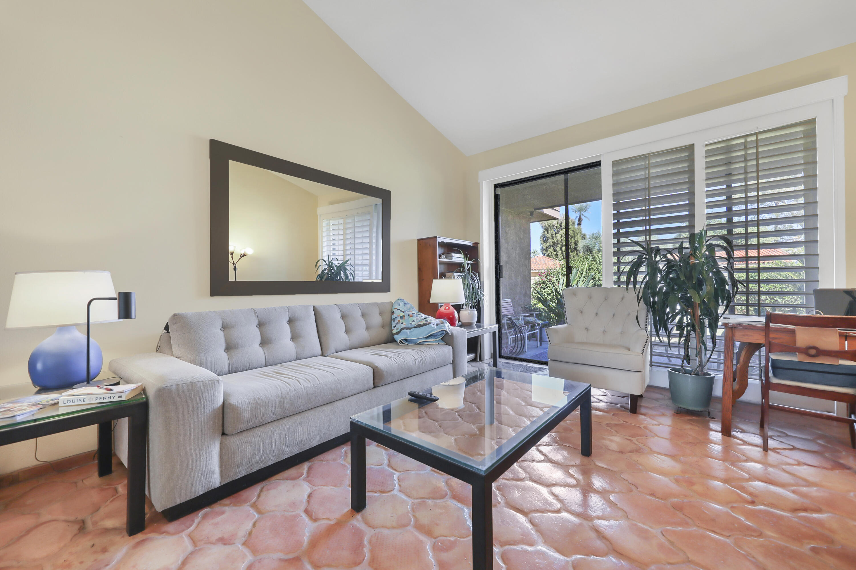 a living room with furniture and a potted plant