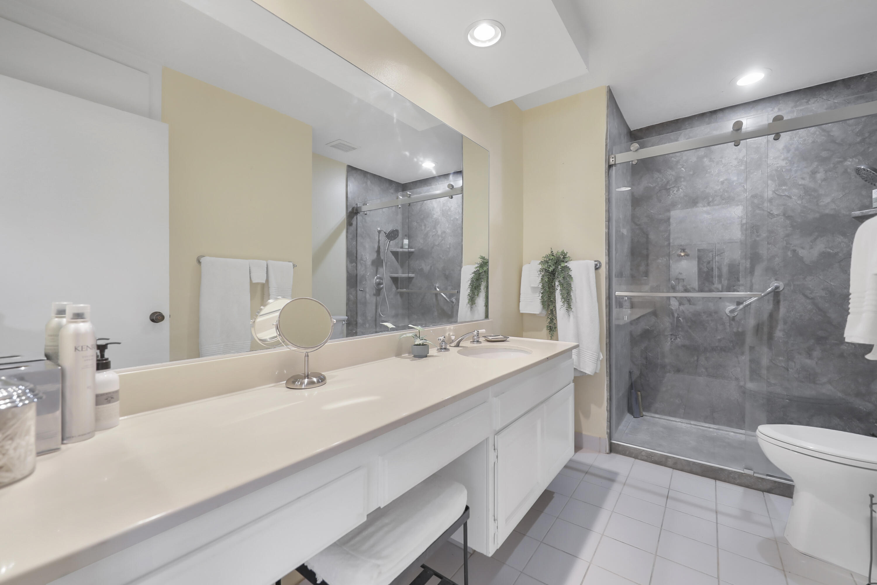 44 Malaga Drive Rancho Mirage, CA 92270 - Photo 13 of 22 a bathroom with a double vanity sink toilet and shower