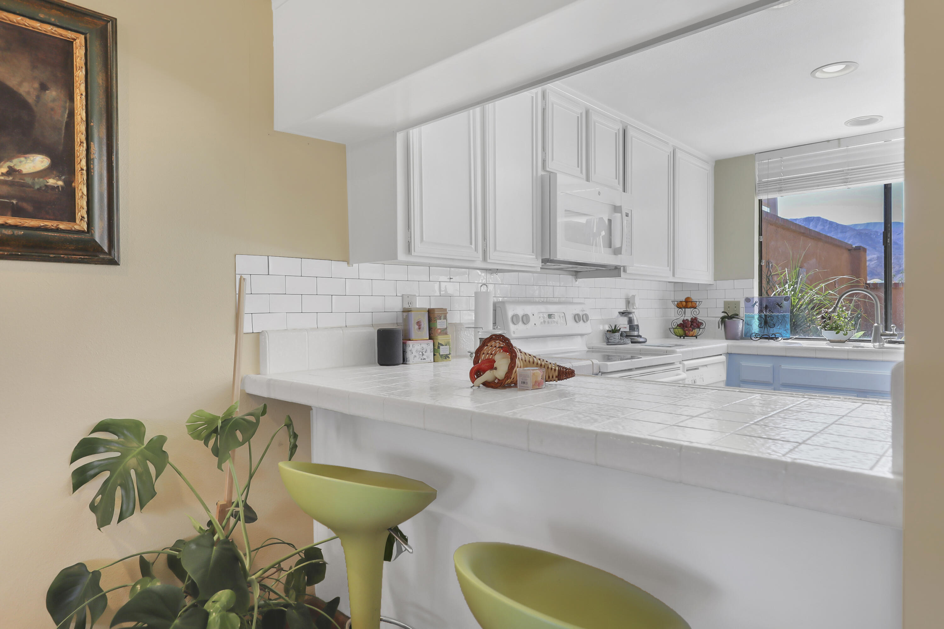 44 Malaga Drive Rancho Mirage, CA 92270 - Photo 6 of 22 a kitchen with stainless steel appliances a sink a window and cabinets