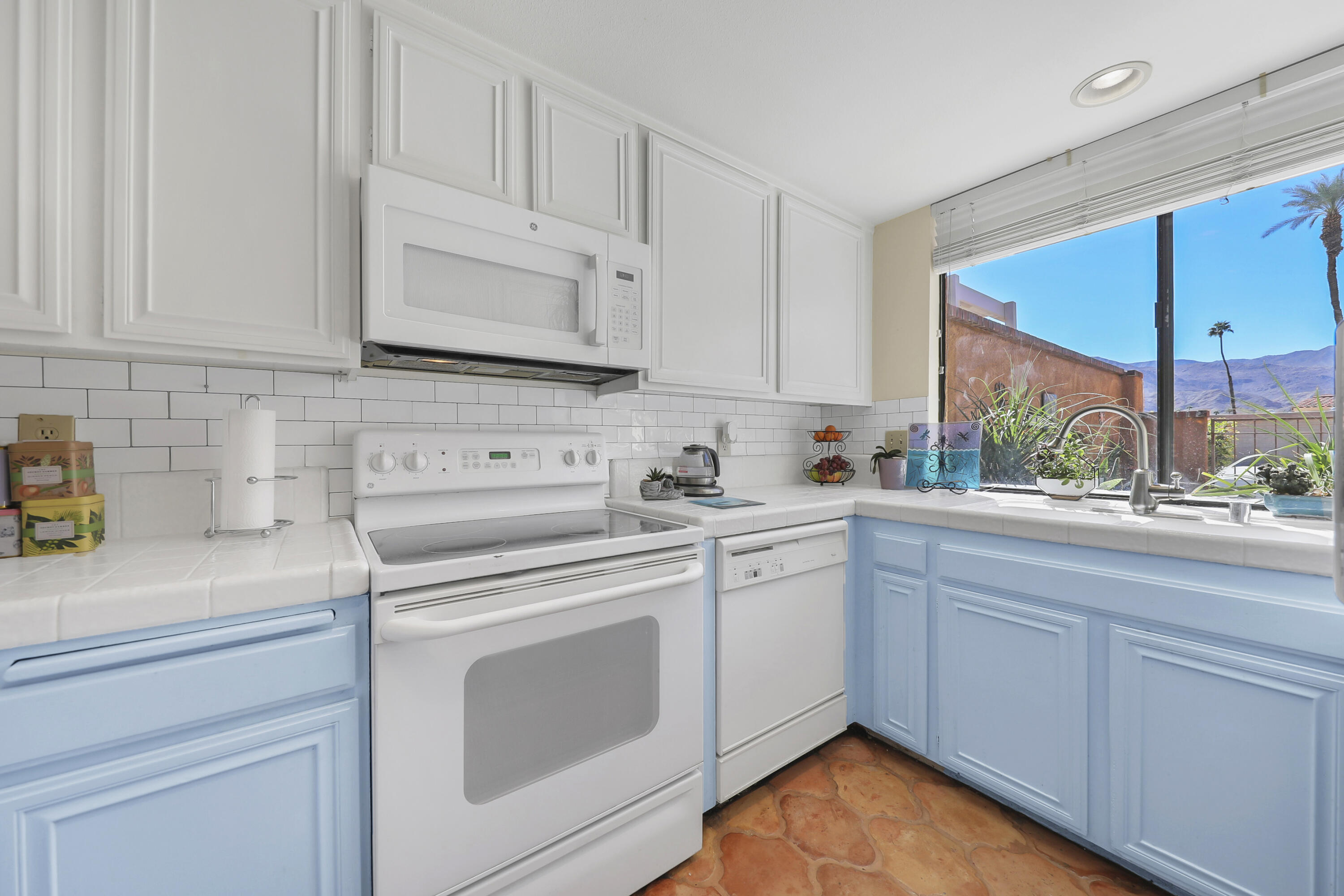 44 Malaga Drive Rancho Mirage, CA 92270 - Photo 8 of 22 a kitchen with white cabinets appliances and a sink