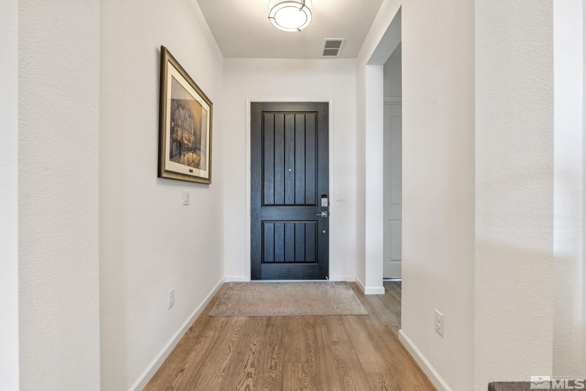 2445 Buttermere Court Reno, NV 89521 - Photo 2 of 39 a view of a hallway with wooden floor and entryway
