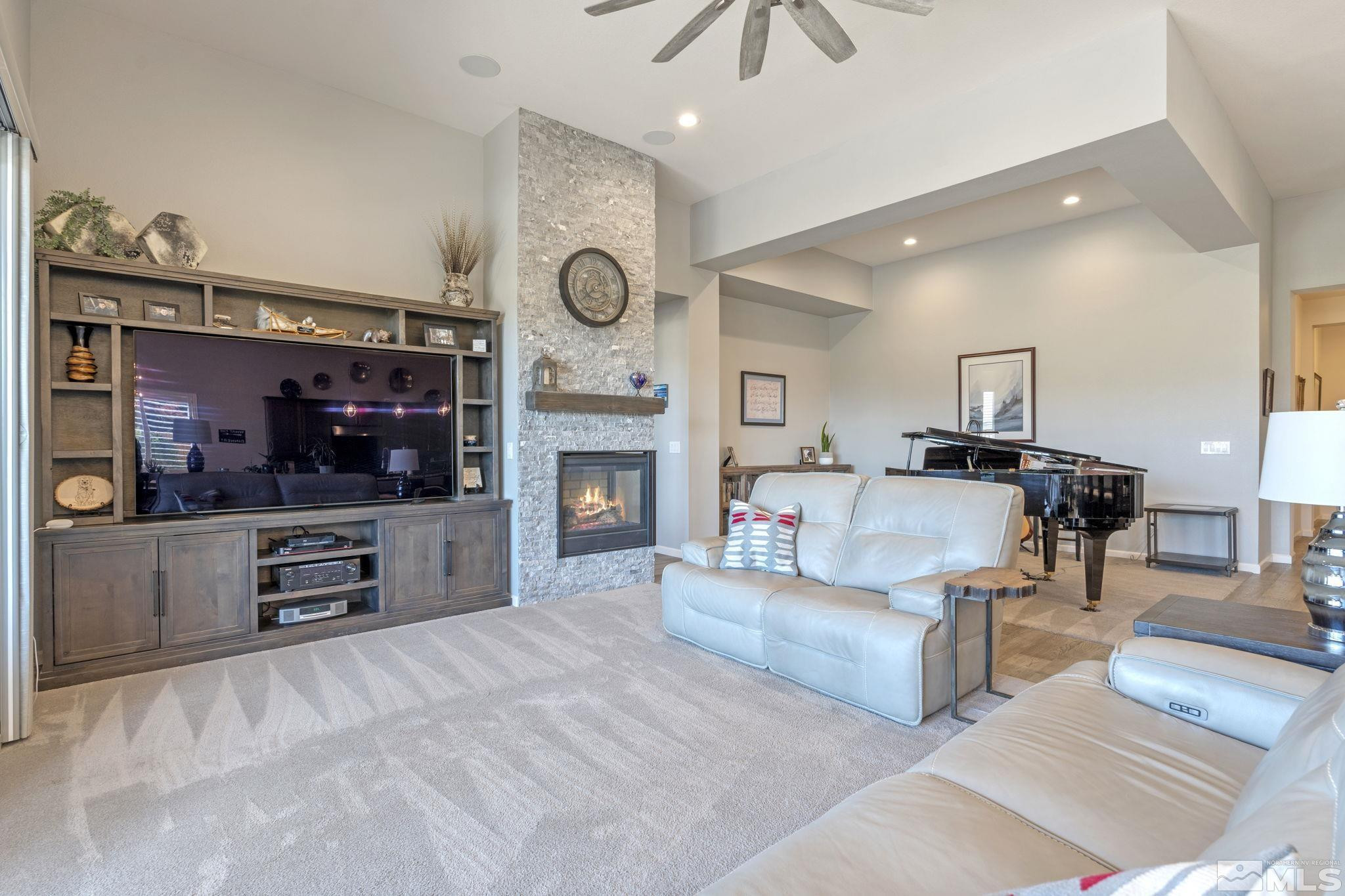 2445 Buttermere Court Reno, NV 89521 - Photo 5 of 39 a living room with furniture a flat screen tv and a fireplace