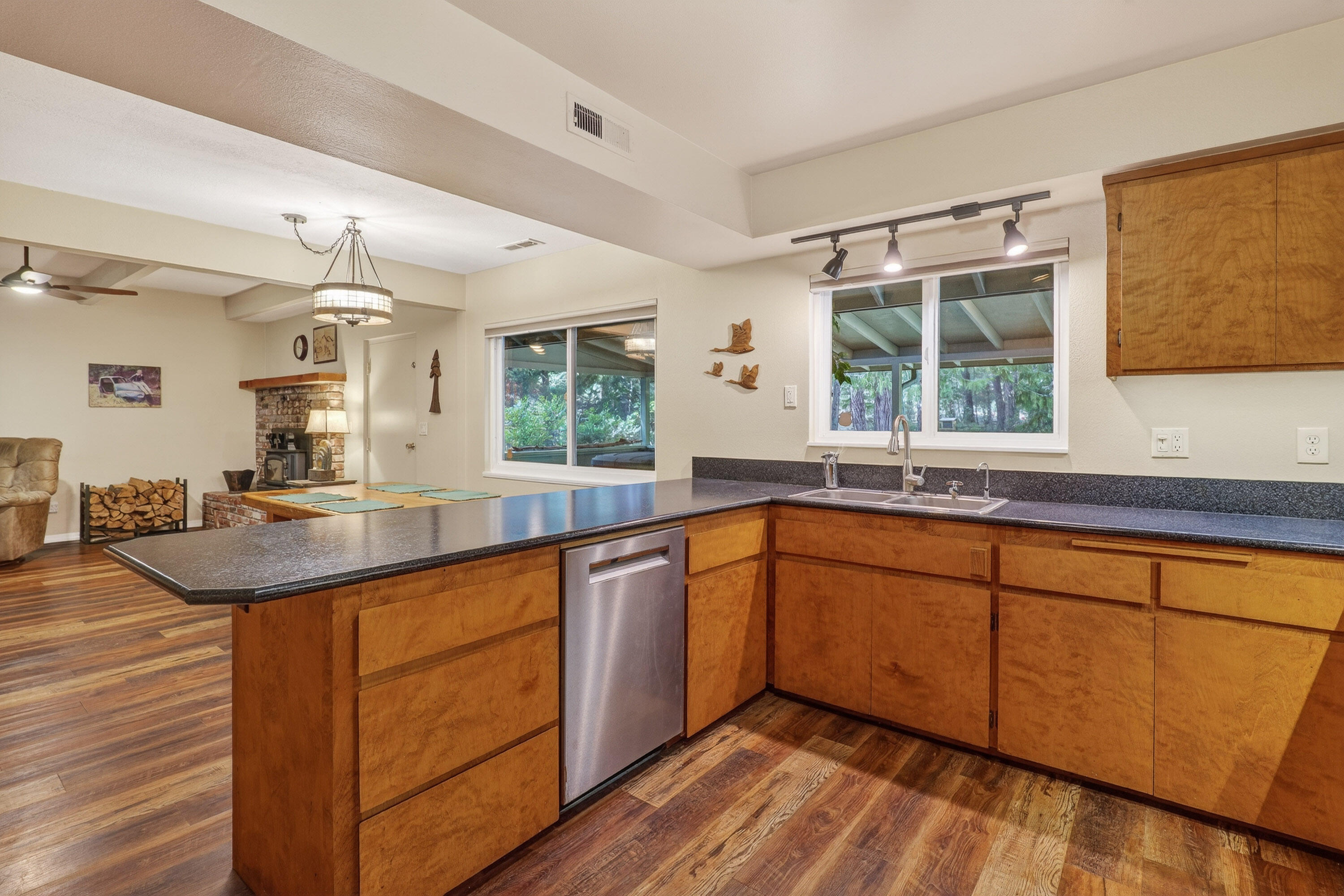 244 Riessen Road Grants Pass, OR 97526 - Photo 14 of 52 a kitchen with stainless steel appliances granite countertop a sink and wooden cabinets