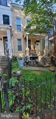 a front view of house with a garden