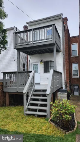 a view of a house with wooden deck