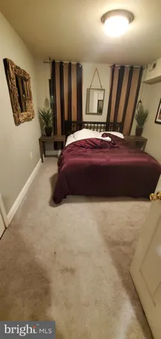 a bedroom with a bed a lamp and window