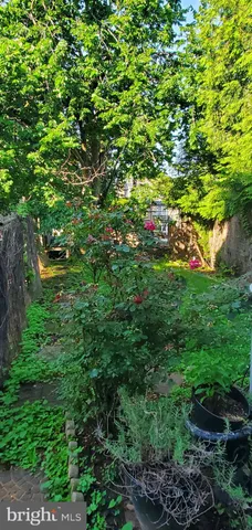 a backyard of a house with lots of green space and garden