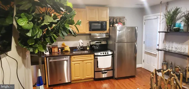 a kitchen with stainless steel appliances a refrigerator a stove a microwave and cabinets