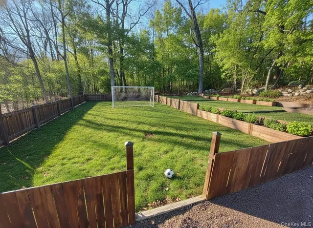 a view of a backyard with wooden fence