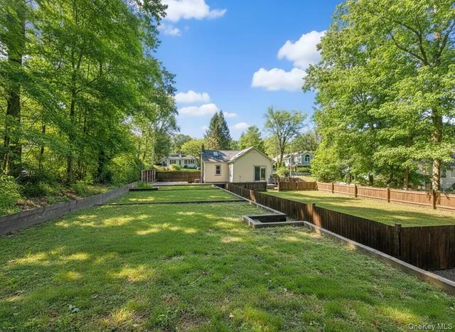 a view of a green field with sitting area
