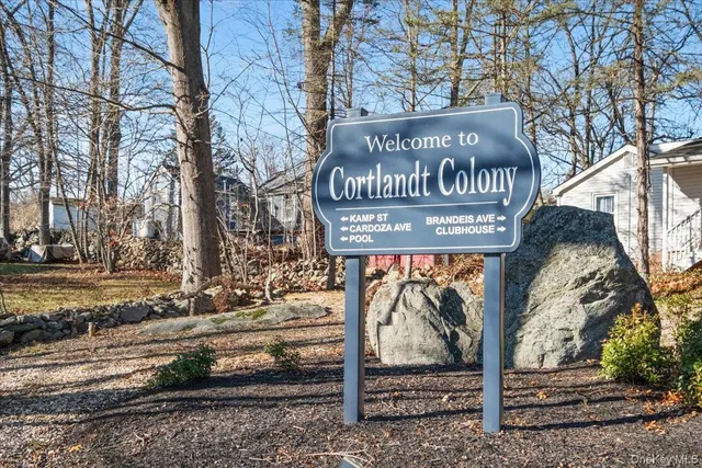 a view of a street sign under a large tree