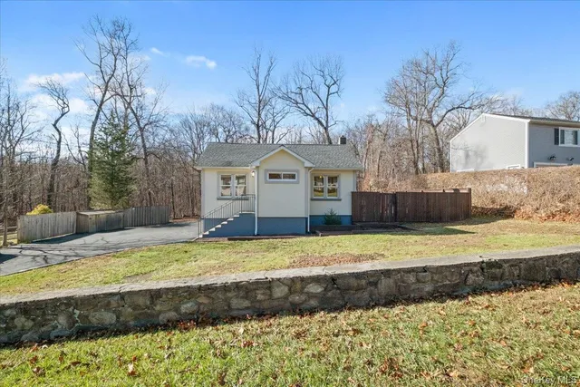 a view of a house with a yard covered with snow in the background