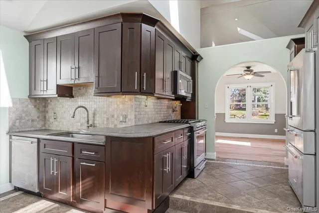 a kitchen with stainless steel appliances granite countertop a sink stove and cabinets