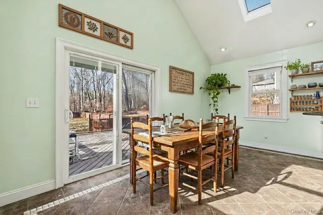 a view of a dining room with furniture and a window
