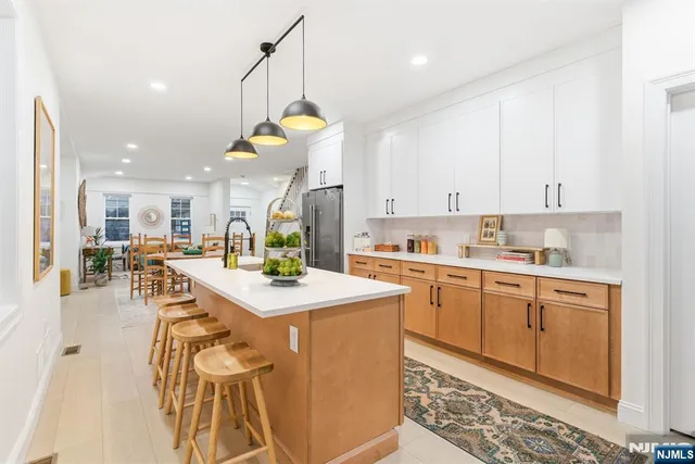 a kitchen with a table chairs stove and cabinets