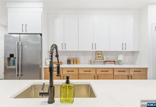 a kitchen with a refrigerator and a sink