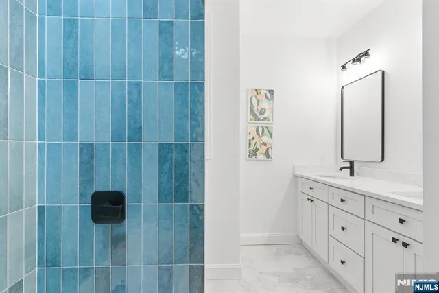 a bathroom with a double vanity sink a toilet and a mirror