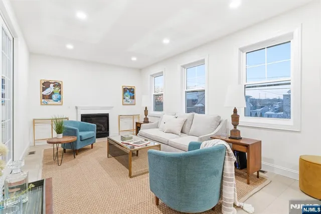 a living room with furniture a fireplace and a window