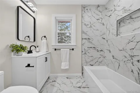 a bathroom with a sink a toilet and a bathtub