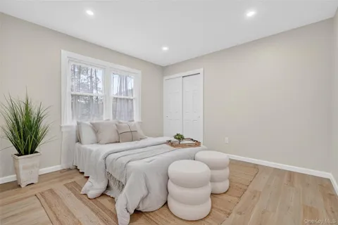 a spacious bedroom with a bed and a potted plant