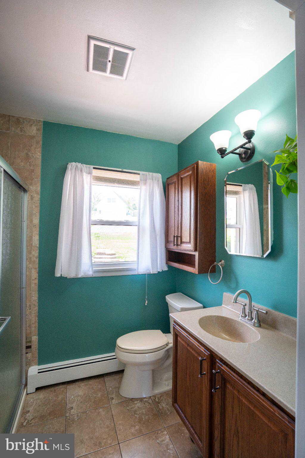 1639 Houserville Road State College, PA 16801 - Photo 13 of 54 Charming bathroom with vibrant teal walls.