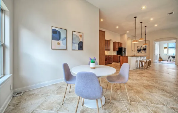 a dining room with furniture and wooden floor