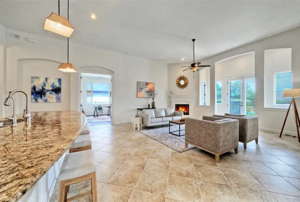a living room with fireplace furniture and a chandelier