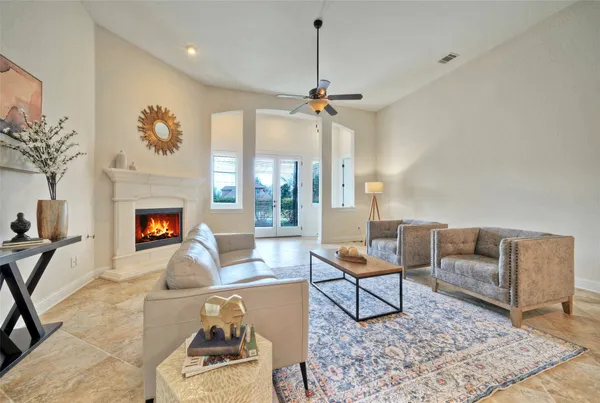 a living room with furniture a rug and a fireplace