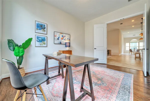 a workspace with furniture and a wooden floor