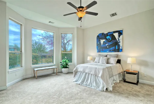 a bedroom with a bed and a painting on the wall
