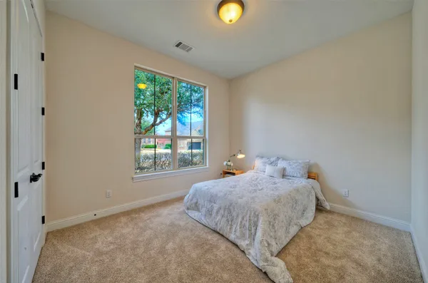 a bed sitting in a bedroom next to a window
