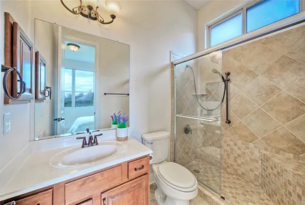 a bathroom with a sink vanity mirror and toilet