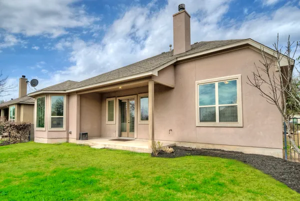 a view of a house with a backyard