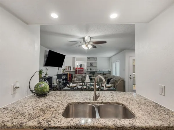 a kitchen counter with a sink and a chandelier