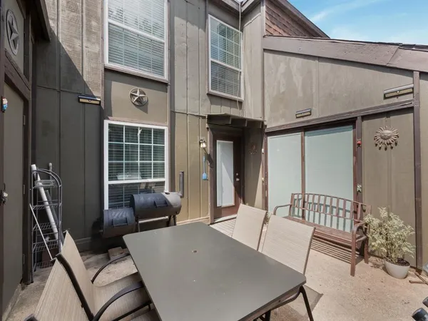 a view of a patio with a table and chairs