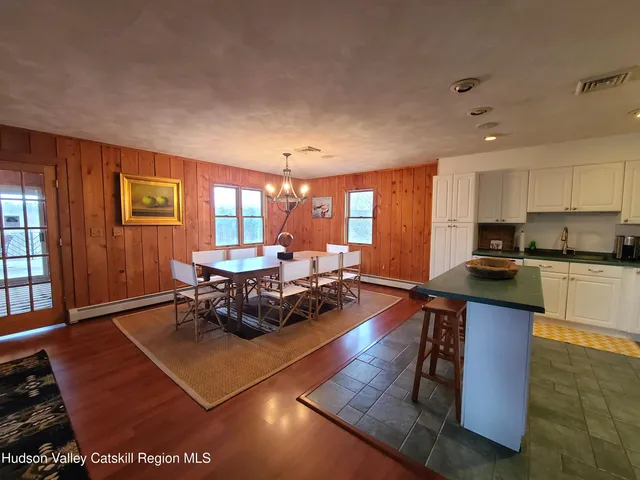 a kitchen with granite countertop a stove and white cabinets