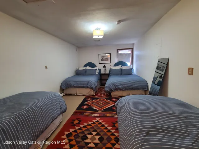 a bedroom with two beds and a lamp