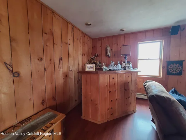 a view of a room with wooden floor closet and windows