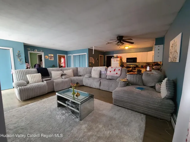 a living room with furniture and a large window