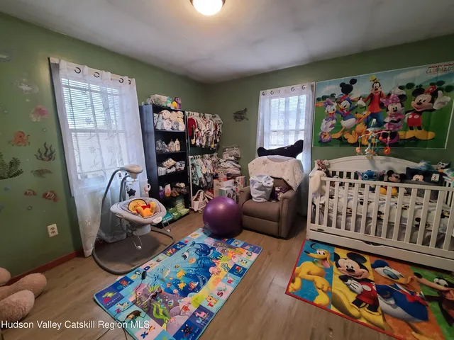 a bedroom with furniture and a book shelf