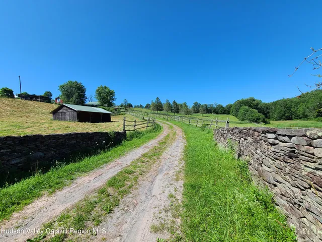 a view of a street with a yard