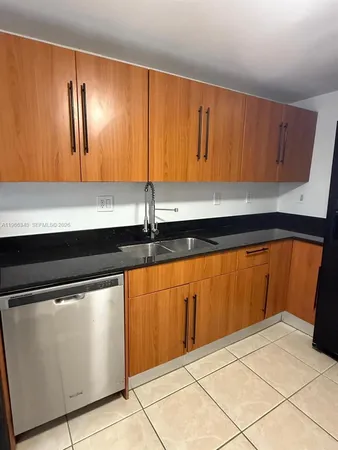 a kitchen with stainless steel appliances a sink and cabinets