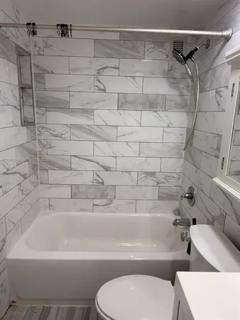 a bathroom with a toilet and a bathtub