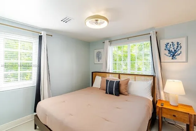 a bedroom with a bed and a painting on the wall