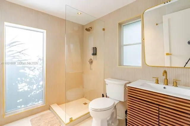 a white toilet sitting next to a shower curtain