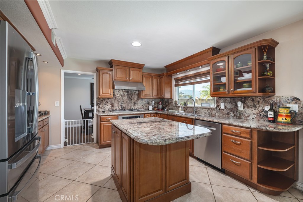 2203 Homewood Avenue Simi Valley, CA 93063 - Photo 7 of 37 a kitchen with stainless steel appliances granite countertop a sink stove and refrigerator
