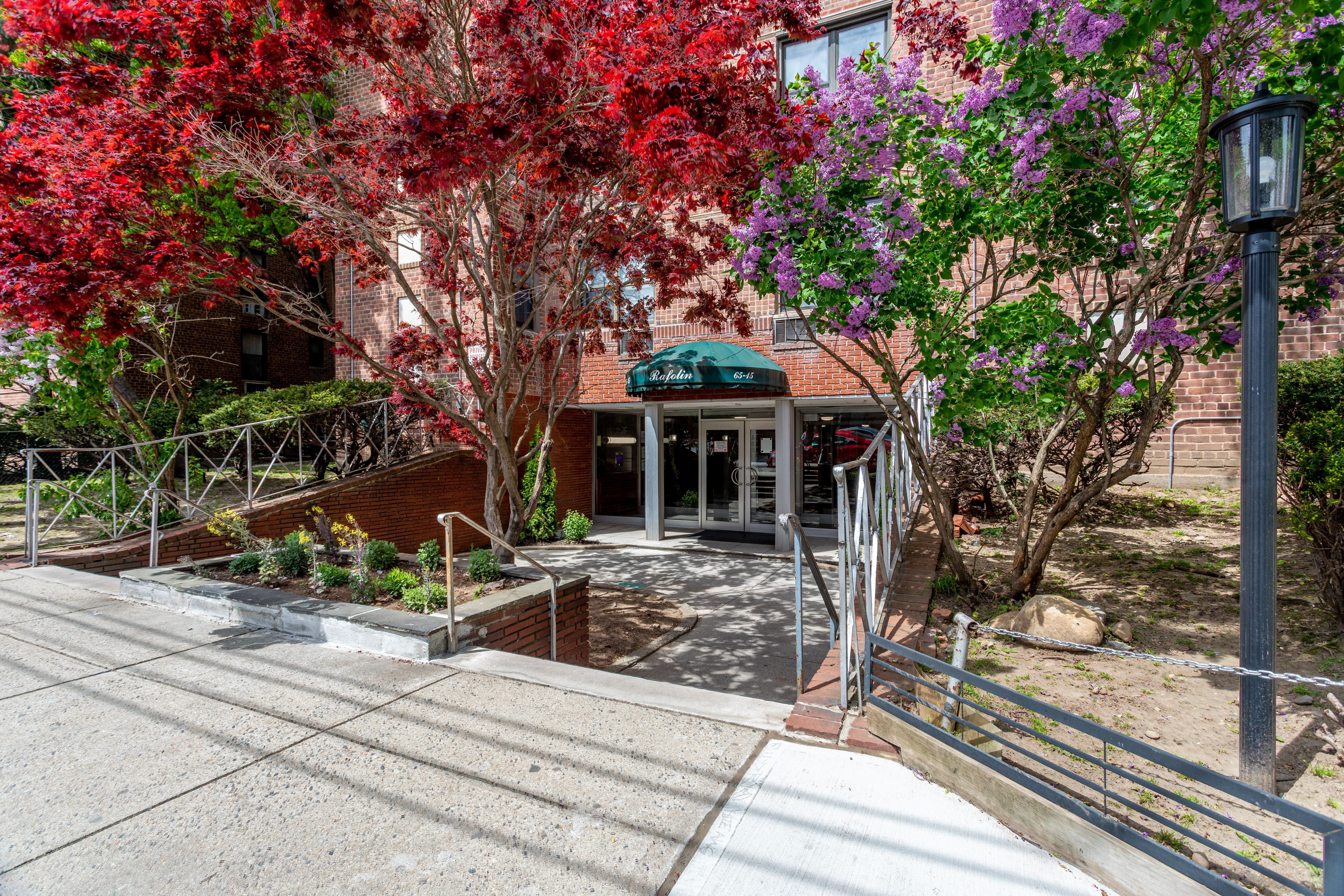 65-15 38th Avenue, Unit 2A Queens, NY 11377 - Photo 16 of 16 a front view of a house with garden